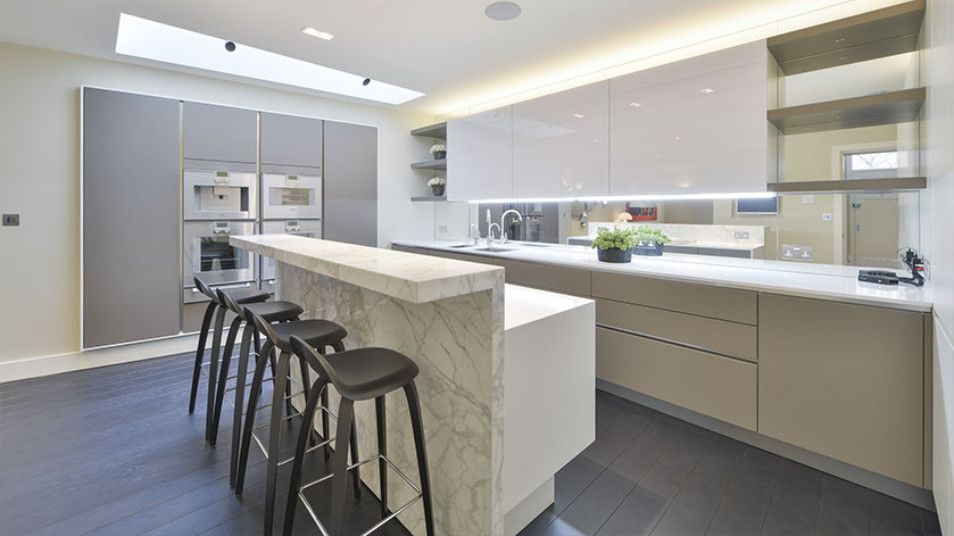 Beautiful kitchen with evidence of natural light through roof light in Chelsea SW7