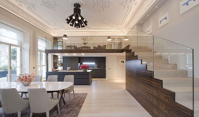 Open plan panoramic view of dining & kitchen area in Kensington including staircase & mezzanine cigar lounge