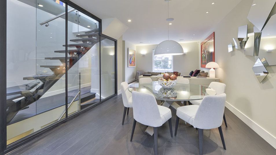 Kitchen glazed wall, self-supporting staircase, open plan seating & dining room in Chelsea SW7